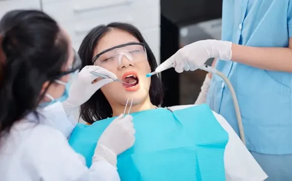 çürük diş tedavisi uygulanan kadın ve diş doktoru